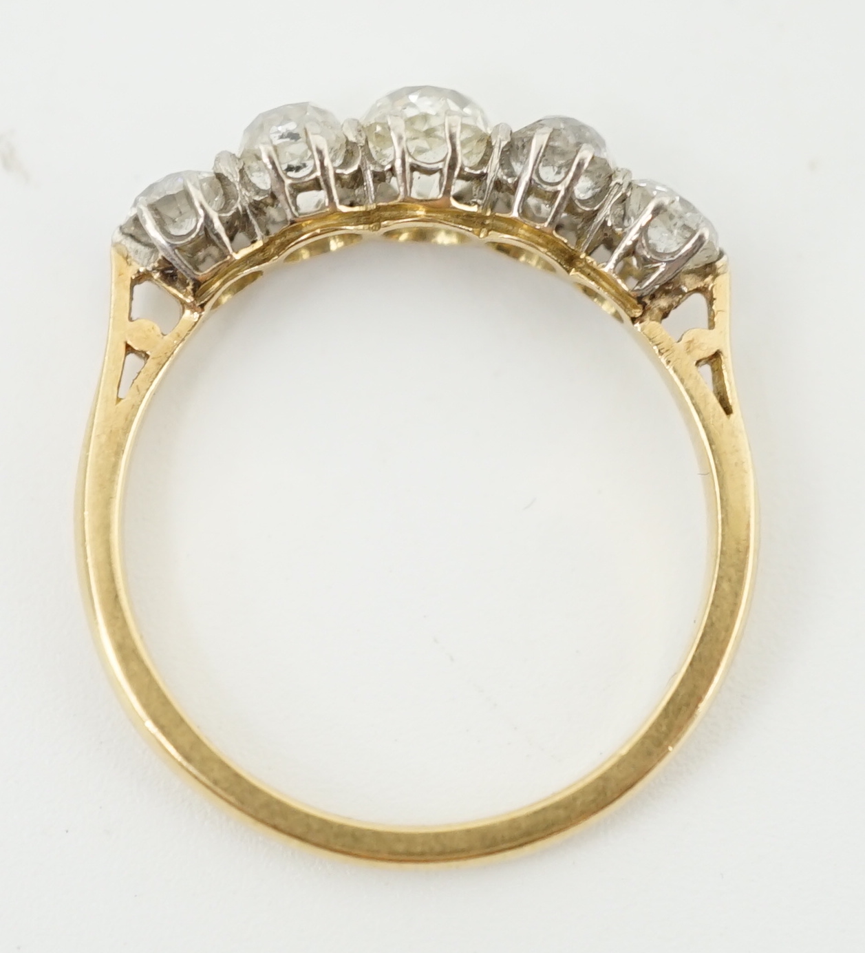 An early to mid 20th century 18ct gold, platinum and graduated five diamond set half hoop ring